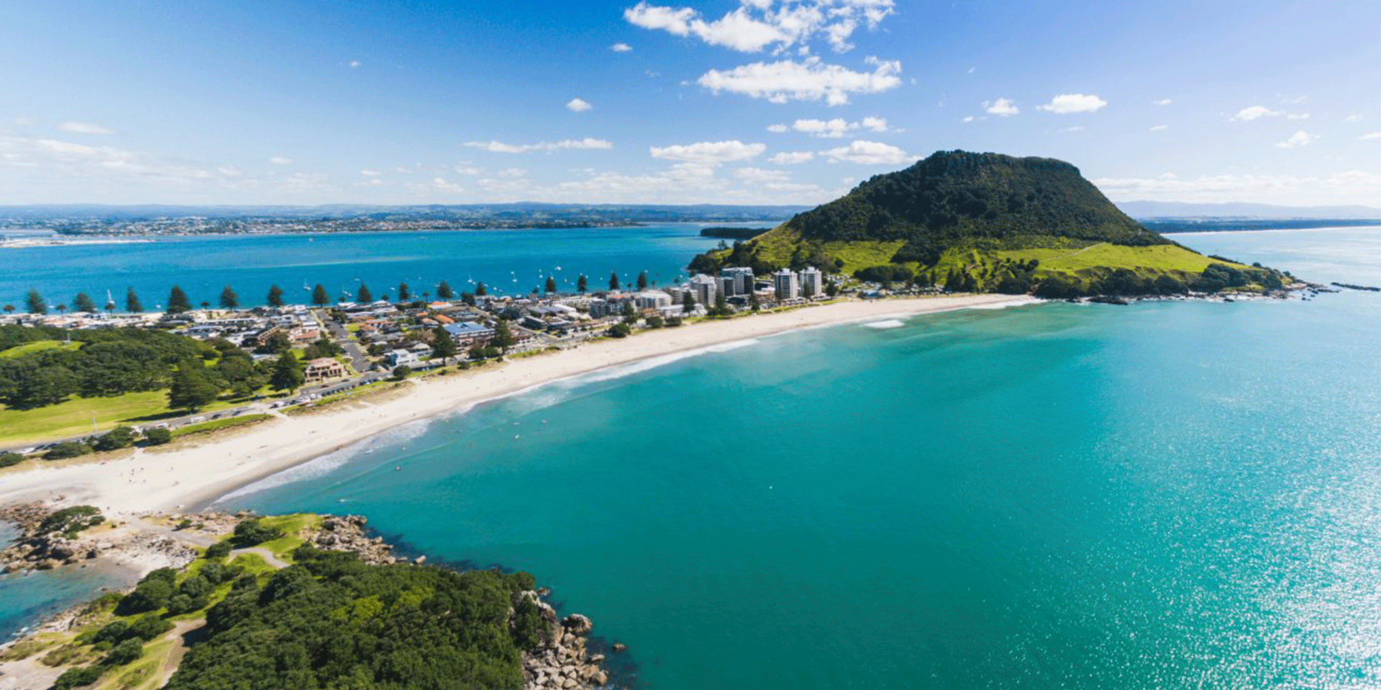 Bird eye view of Mount Maunganui and the surrounding beach on a sunny day